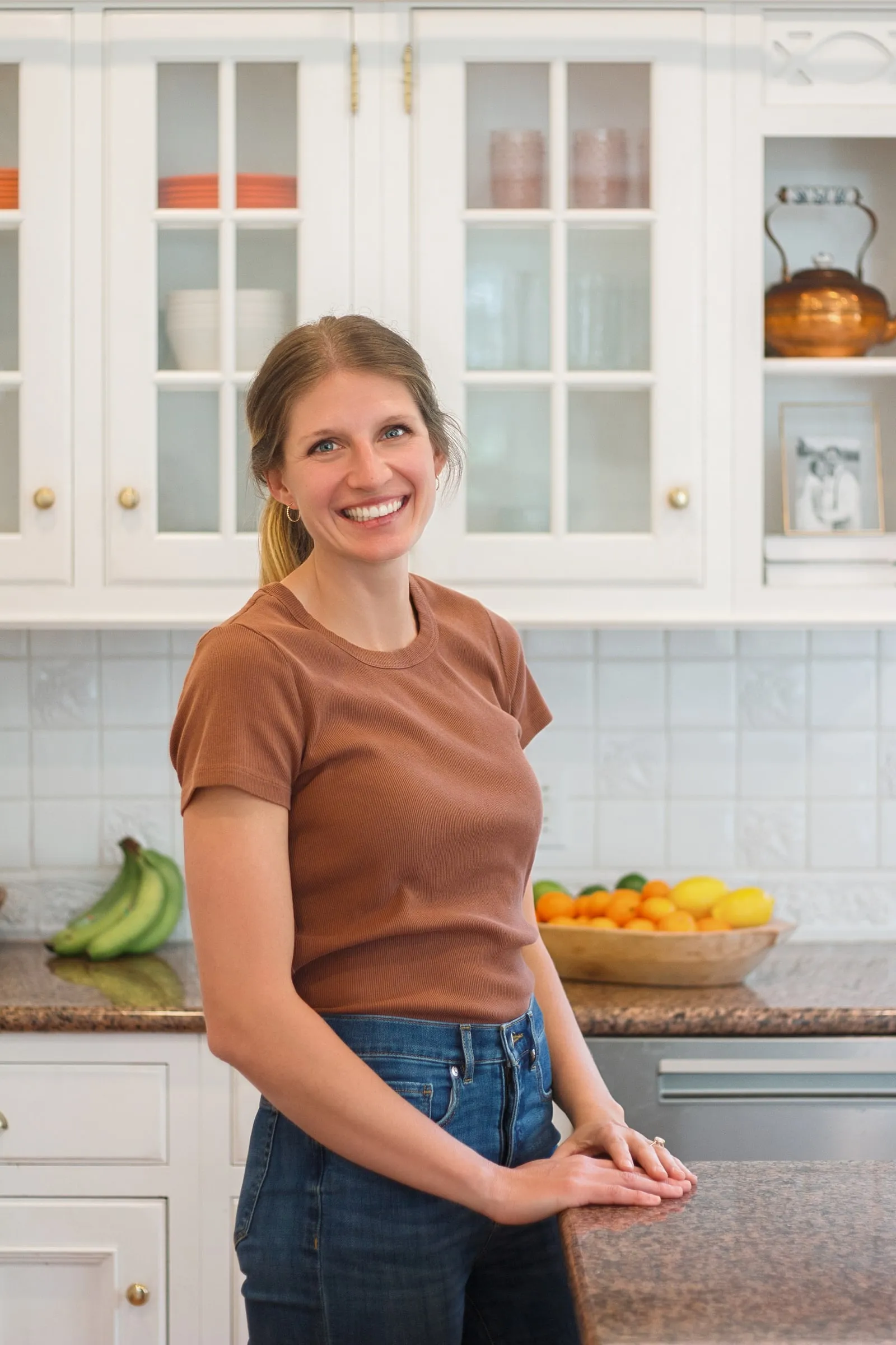 Kelsey Shaughnessy, RDN, leaning on a kitchen counter